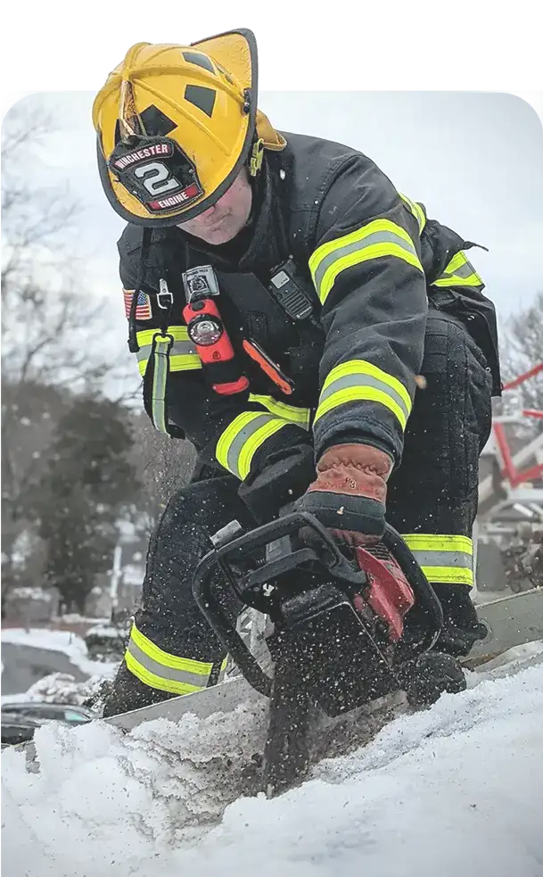 Photo of firefighter cutting a roof